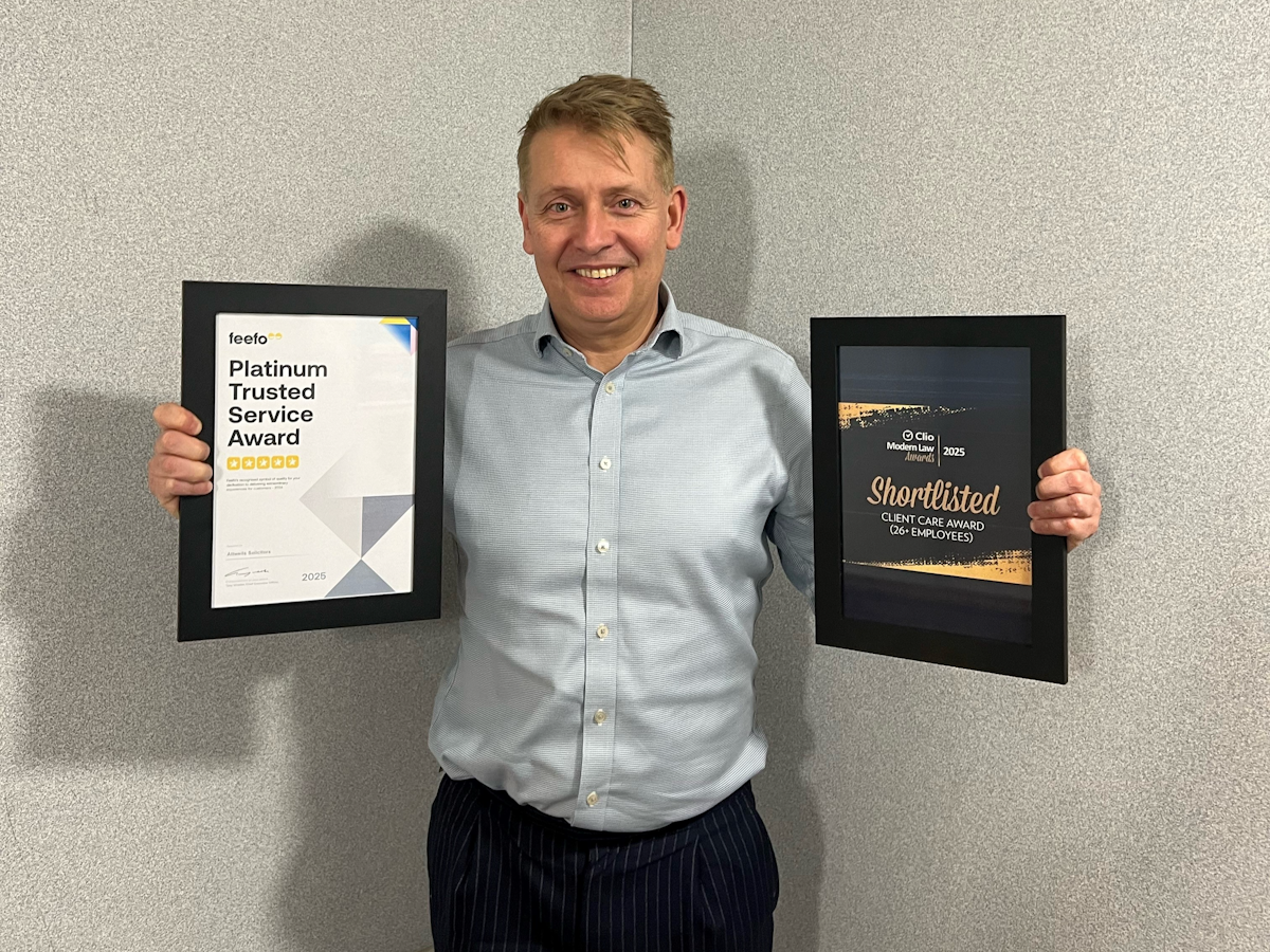 Nick Attwell from Attwells Solicitors holding two awards